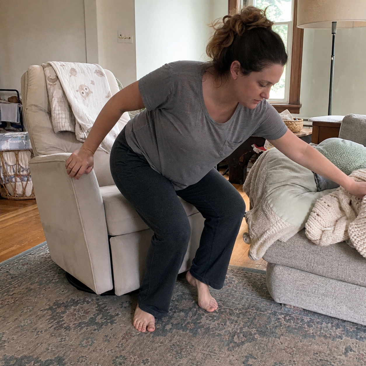 Postpartum mother moving from a feeding chair into the rest of her day