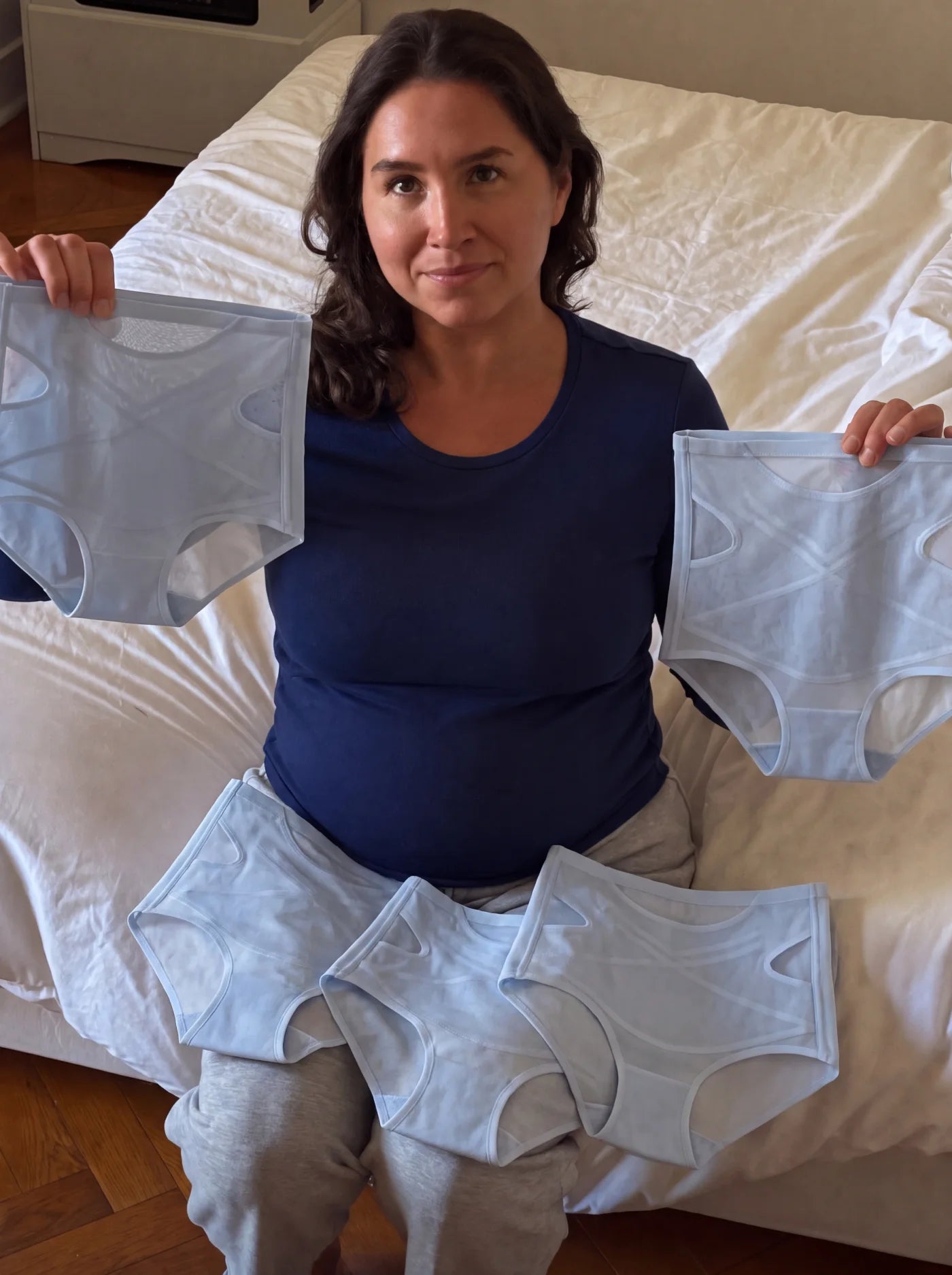 Customer holding five Ice Blue NurtureForm X Matrix briefs